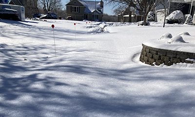 Neighborhood street covered in snow before the snow plow arrives. This snow and ice caused four AMI days the first week of second semester.